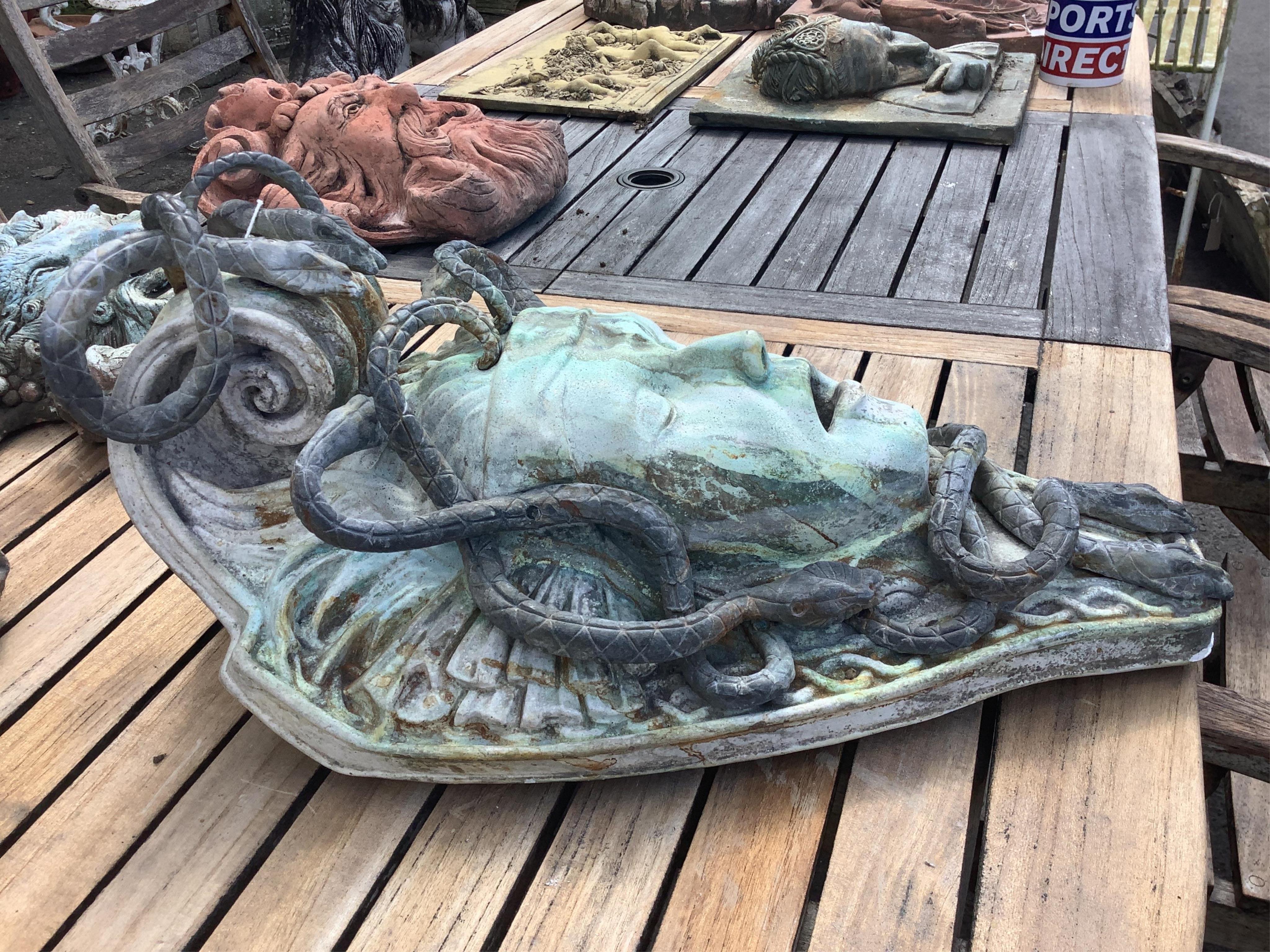 A reconstituted marble and lead Medusa wall fountain head, height 54cm